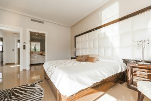 Apartment bedroom with wooden bed frame