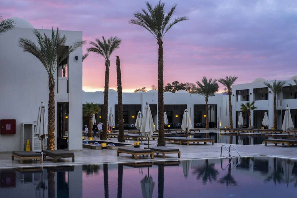 Hotel pool surrounded by palm trees