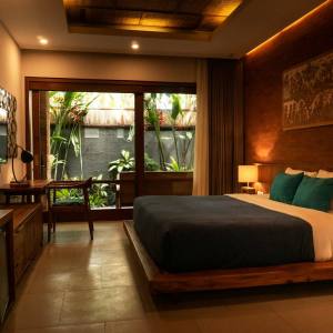 Hotel bedroom with wooden bed and garden view