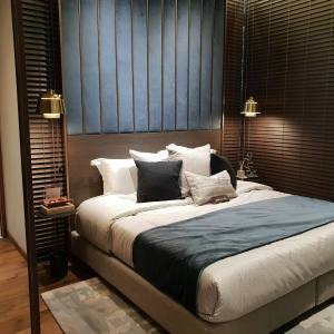 Bedroom with blue upholstered headboard