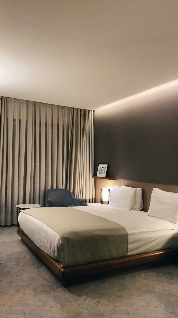 Hotel bed with grey pillows